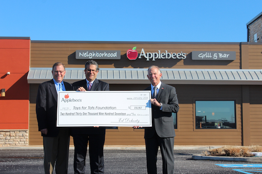 Kevin Coughlin, director of operations and David DiBartolo, vice president of operations, present a check to Lieutenant General Pete Osman, president and chief executive officer of Toys for Tots. Courtesy photo
