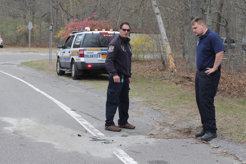 Paramedics Ray Bonner and Joseph Oliver yesterday puzzled over the crash's sequence of events. Photo: Denise Civiletti