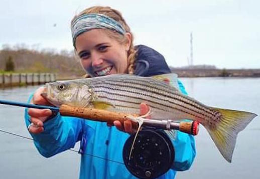 Liz Ziebarth with a bass caught on a clouser minnow. Courtesy photo: Rob Thompson 