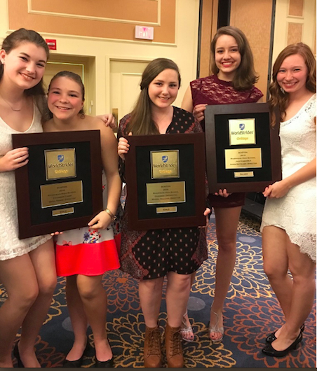 Senior musicians (L-R: Jessica Nicholson, Kaitlyn Jehle, Megan Brunner, Hayley Bingham and Lauren Schmitt) hold some of the awards the three ensembles won.