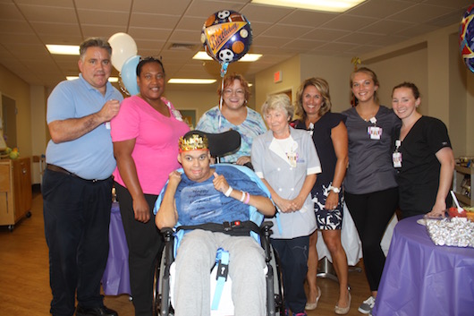 Michael Hubbard and members of the PBMC Skilled Nursing Facility Staff who care for him. Photo: Peter Blasl