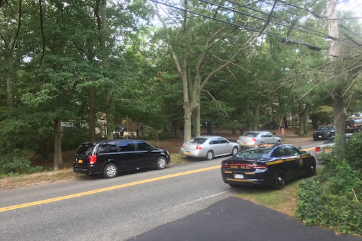 State Police vehicles outside the home oat 727 Mill Road, where police said Brown had her handcuffs removed with a hacksaw Saturday during a police pursuit. Police executed a search warrant at the home early Sunday morning. Photo: Peter Blasl
