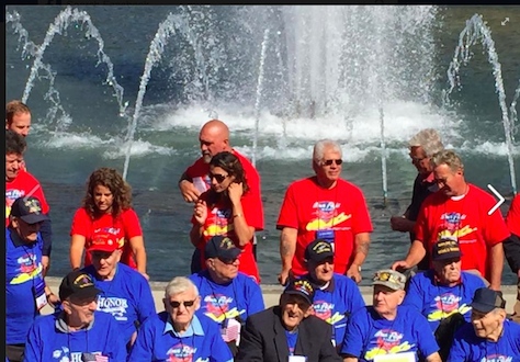 Honor Flight veterans and their guardians in front of the World War II memorial fountain.