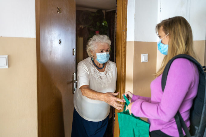 2020_1114_woman delivering food to senior