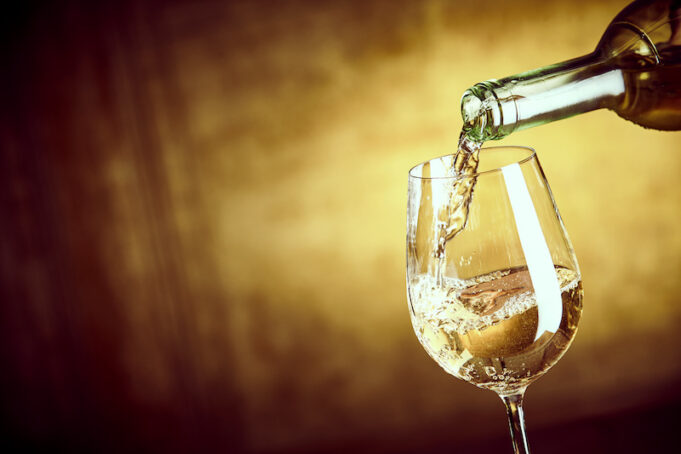 Banner ofPouring a glass of white wine from a bottle