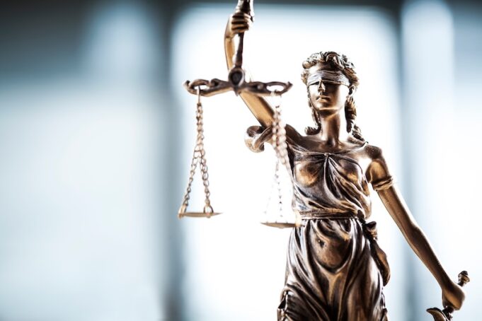 Statue of justice blindfolded woman holding scales