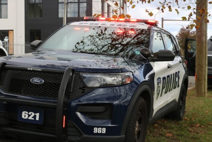 A parked Riverhead Police vehicle with lights on.